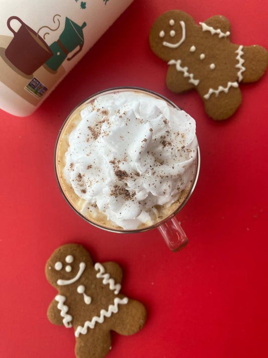 Gingerbread collagen latte with Sproos MCT Collagen Creamer and gingerbread cookies. Latte is topped with whipped cream and nutmeg.